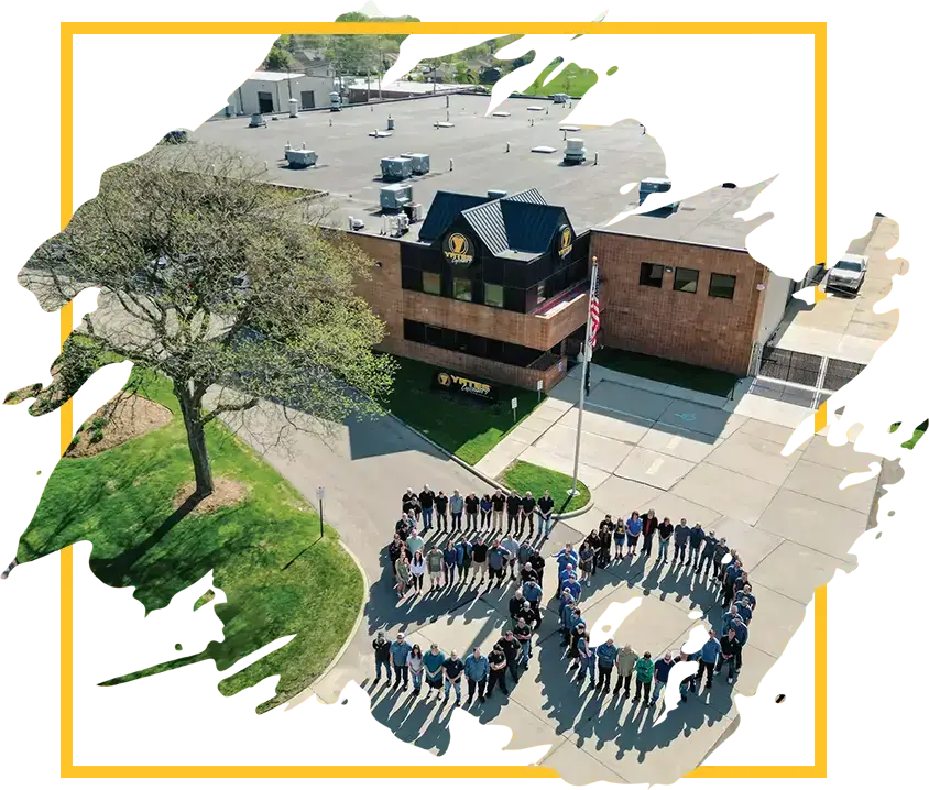 Yates Industries facility with staff standing to spell "50" for their 50th anniversary